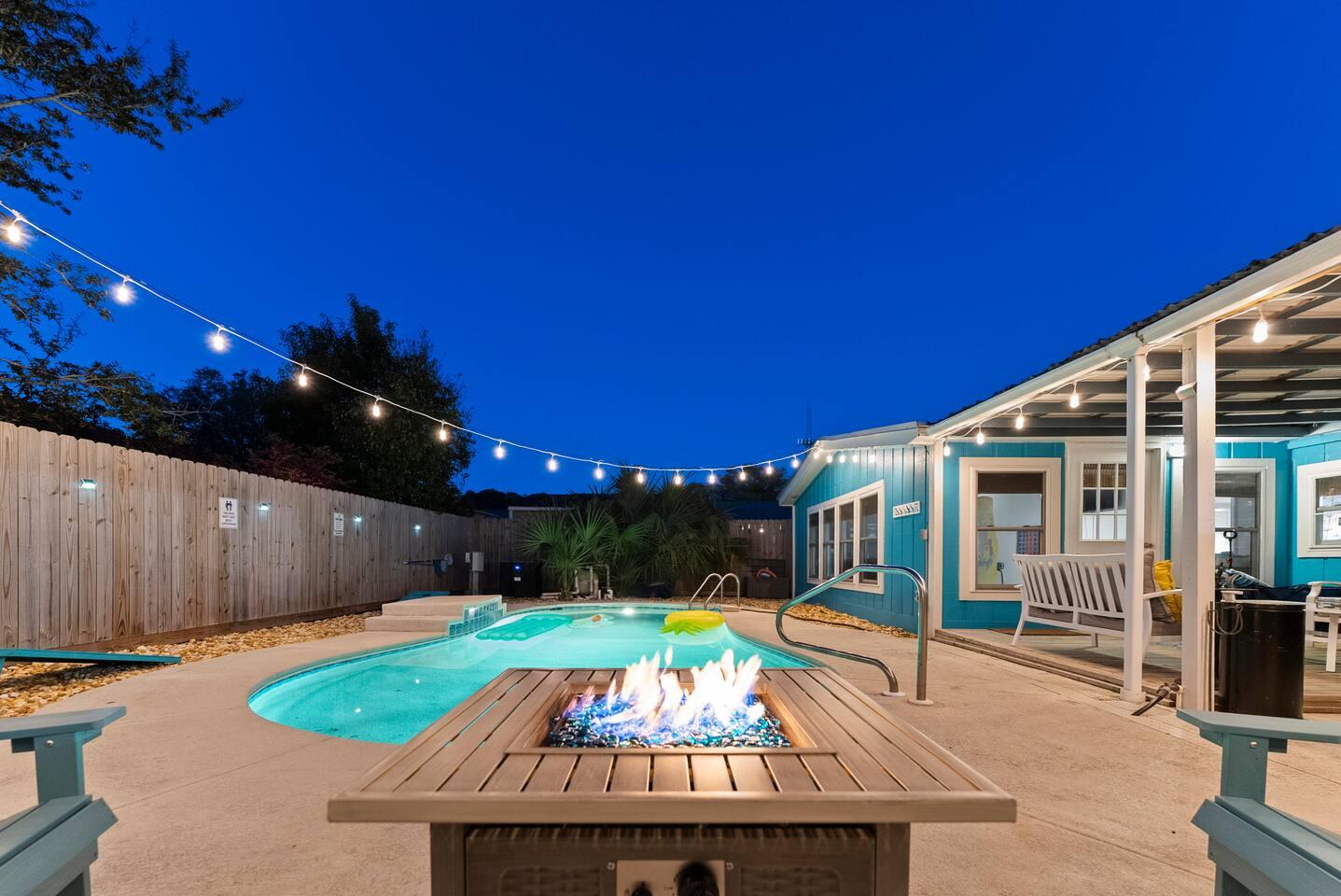 Turquoise Tui backyard pool at dusk